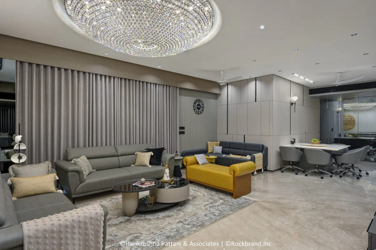 4 BHK living room interior design at Sharanya Skyvue Ahmedabad with chandelier and grey theme