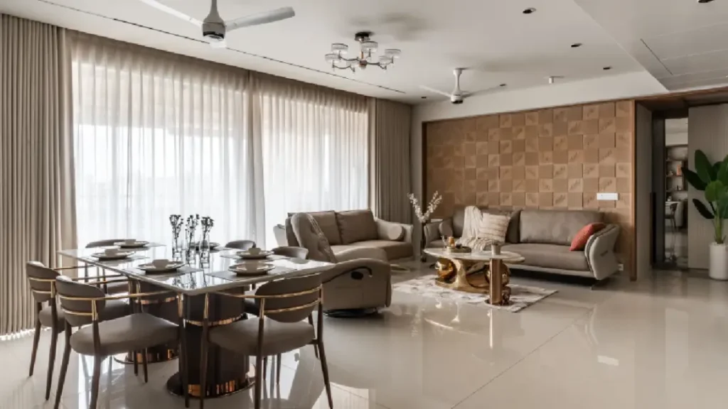 Open plan living and dining room with black glass 8-seater dining table, gold frame chairs, taupe leather sofas, gold swan coffee table base, and 3D leaf-pattern wall panel - 4 BHK interior Thaltej Ahmedabad